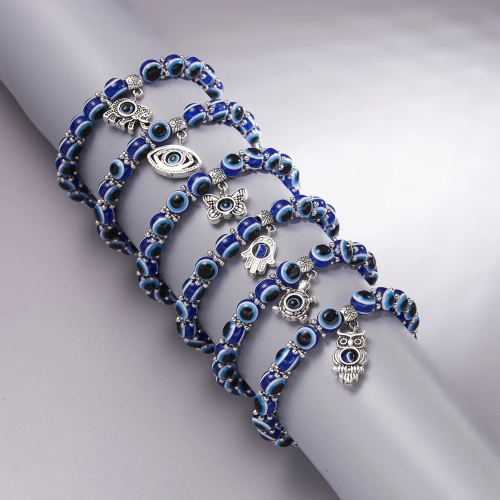 Stackable Evil Eye protection anklet for unisex wear. Blue beaded stretch fit spiritual jewelry with a charm.