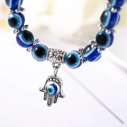 Unisex Evil Eye Anklet featuring an Elephant charm for strength & good fortune. Blue beaded stretch fit jewelry.