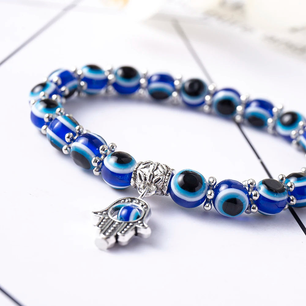 Unisex Evil Eye Anklet with a Butterfly charm, symbolizing transformation & beauty. Blue beaded stretch fit jewelry.