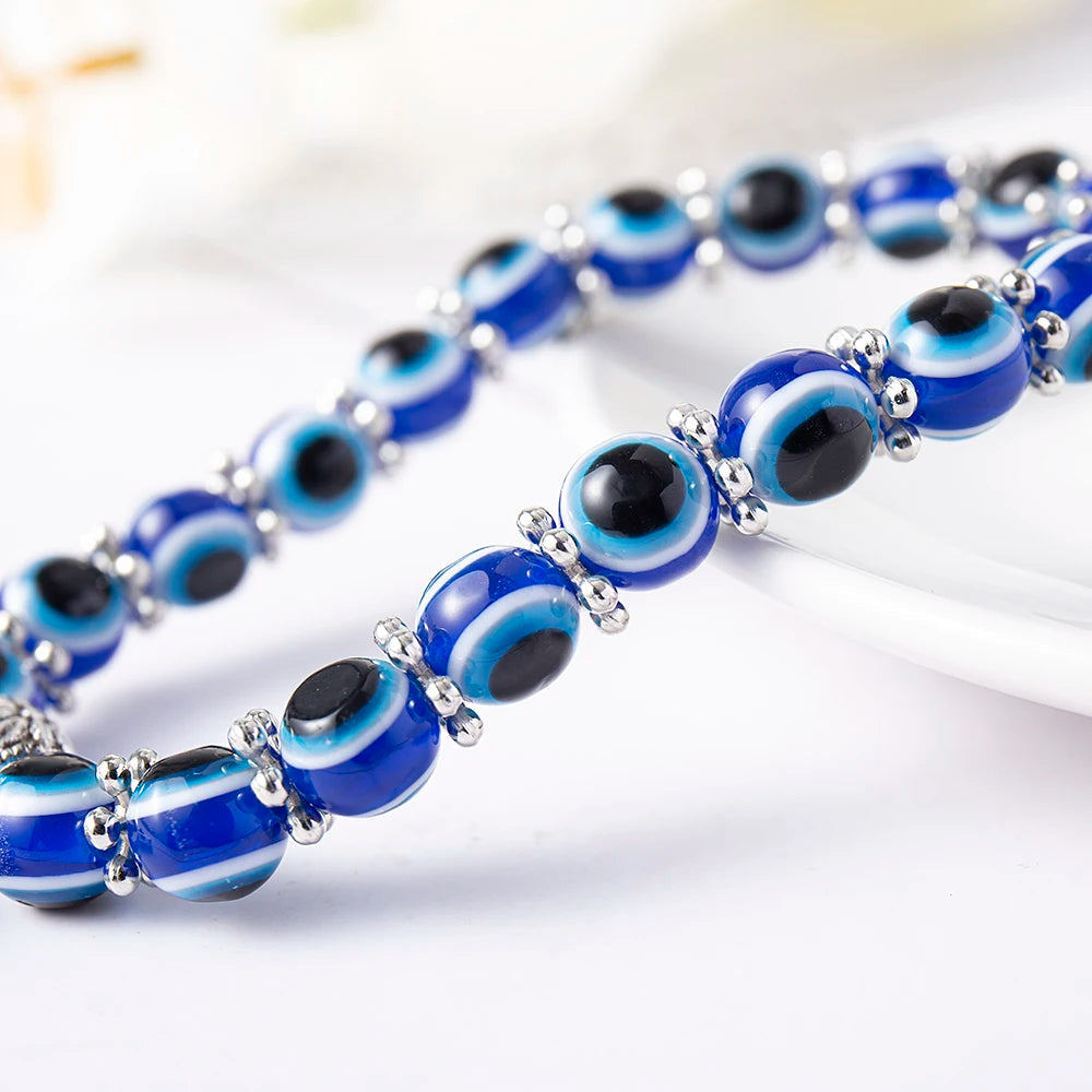 Unisex Evil Eye Anklet with a Turtle charm for longevity & stability. Blue beaded stretch fit spiritual jewelry.