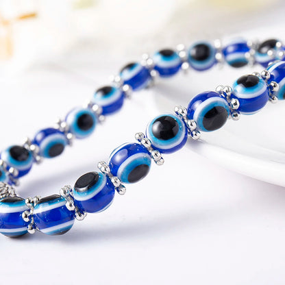 Unisex Evil Eye Anklet with a Turtle charm for longevity & stability. Blue beaded stretch fit spiritual jewelry.