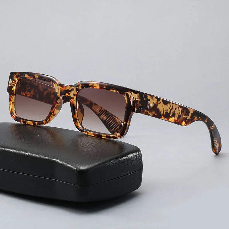 Close-up of trendy unisex fashion sunglasses, highlighting the unique leo print pattern and quality frame.