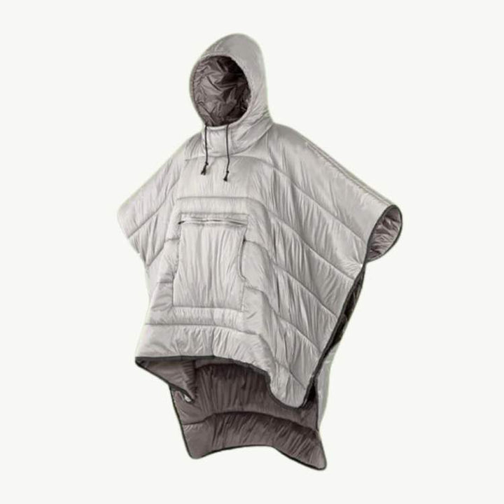 Happy hiker wearing a warm fleece-lined poncho, enjoying the outdoors while staying dry and comfortable