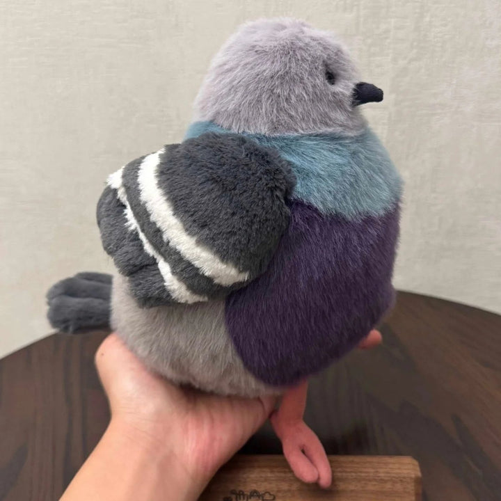 Close-up of the fluffy pigeon plush toy, showcasing its soft texture, a comforting stuffed animal for cuddling.