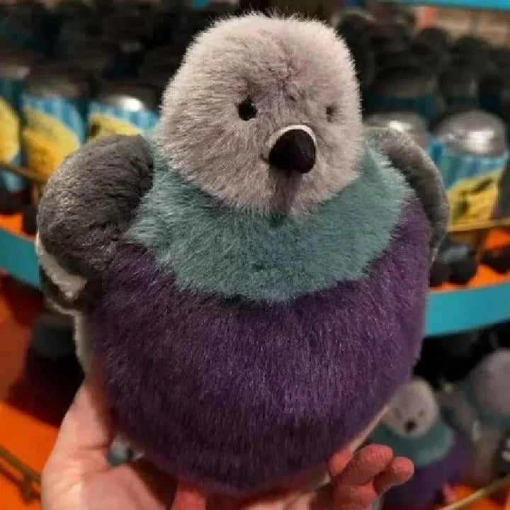 Hands gently holding a fluffy pigeon plush toy, a soft unisex comfort stuffed animal, perfect for cuddling.