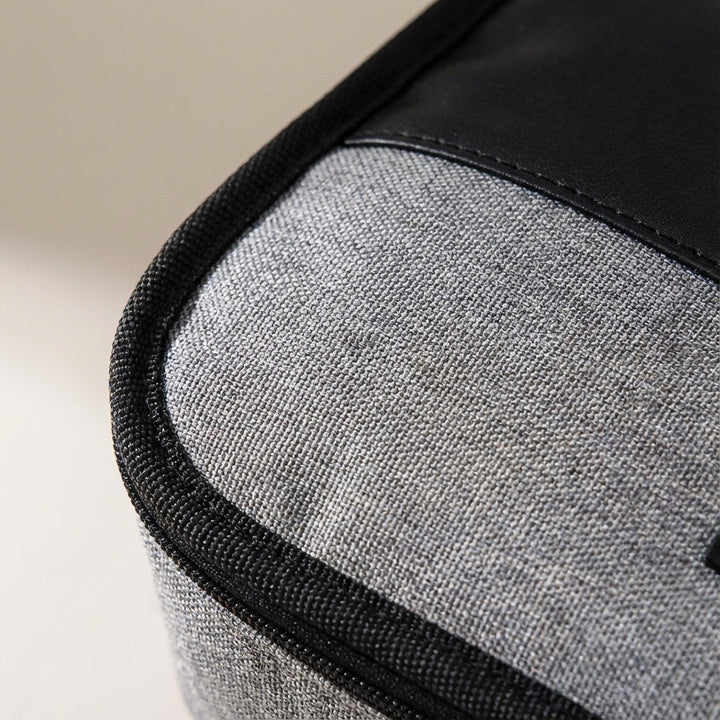 Hanging water-resistant toiletry bag, displaying organized bathroom storage for travel essentials.