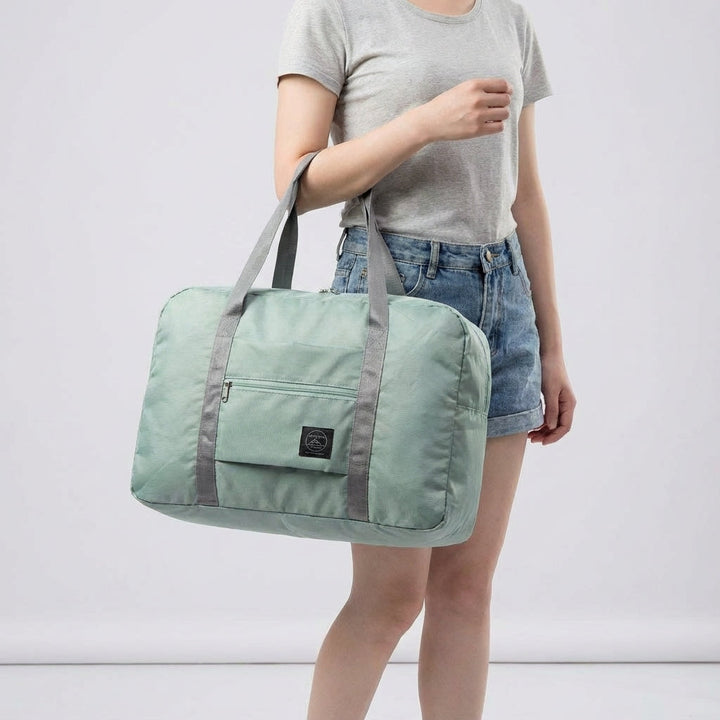 Compact folded lightweight duffel bag. Ideal personal item for easy storage in luggage or home.