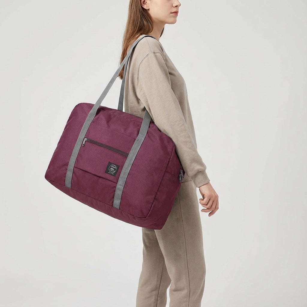 Foldable lightweight travel duffel bag packed for a weekend trip. Perfect as a personal item or carry-on.