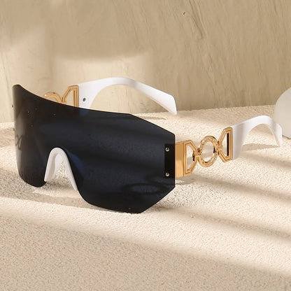 Elegant unisex frameless sunglasses with UV400 eye protection. Features bold, futuristic style & gold temples.