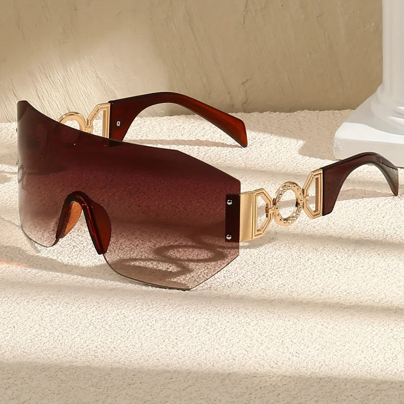 Bold frameless sunglasses with gradient lenses & gold temples. Unisex futuristic fashion accessory, UV400 protected.