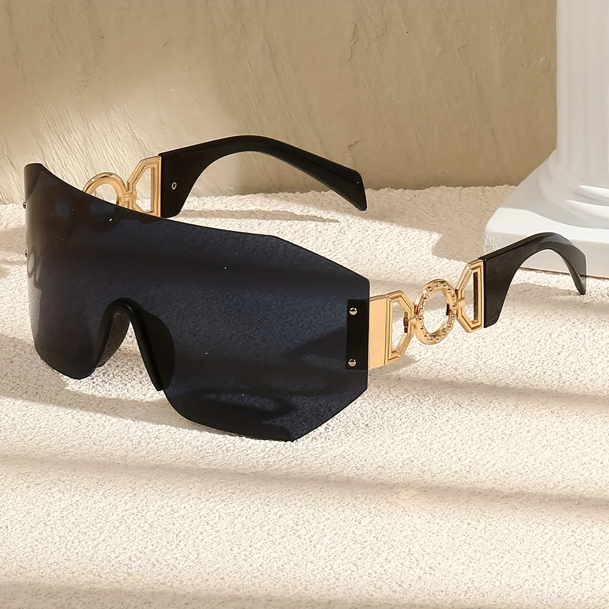 Unisex futuristic frameless sunglasses. Essential fashion accessory with UV400 protection & elegant gold temples.