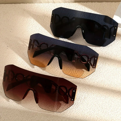 Close-up of futuristic frameless sunglasses with shiny gold temples & gradient lenses. Provides UV400 protection.