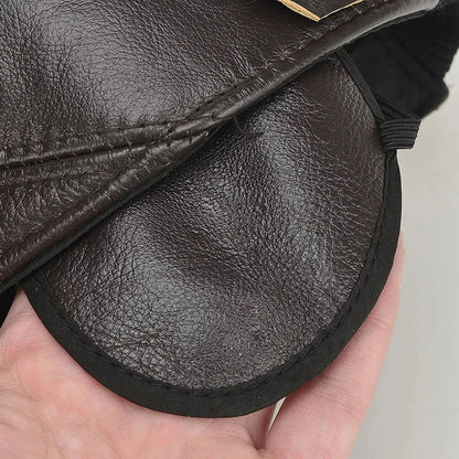 Front view of a stylish unisex genuine leather cap with warm fleece lining. A classic adjustable winter hat accessory.