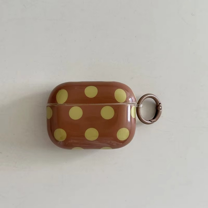 Chic earphone accessory: Glossy polka dot earbud cover with a durable design & convenient ring for portability.