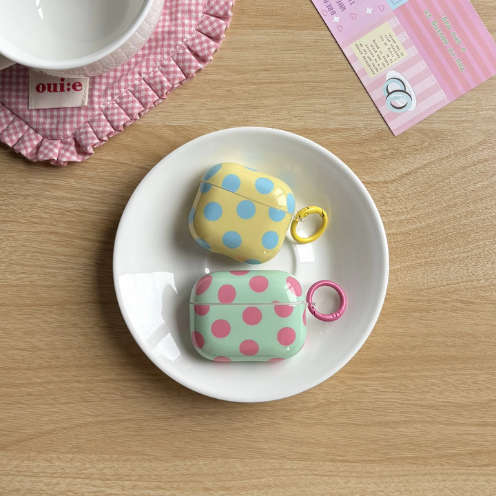 Portable fashion accessory: Glossy polka dot earbud case with ring cover, protective & lightweight.