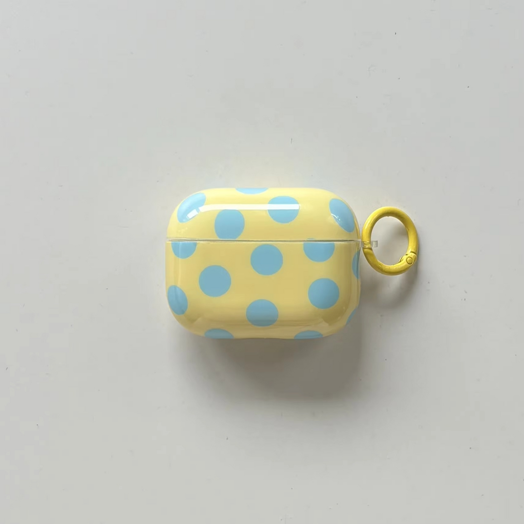 Glossy polka dot wireless earbud case, a protective tech accessory with a sturdy ring cover.