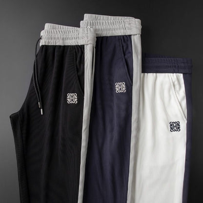 Unisex Hali Comfort Pants in black, white, or blue. Versatile, flexible, and comfortable for casual and athletic everyday wear.