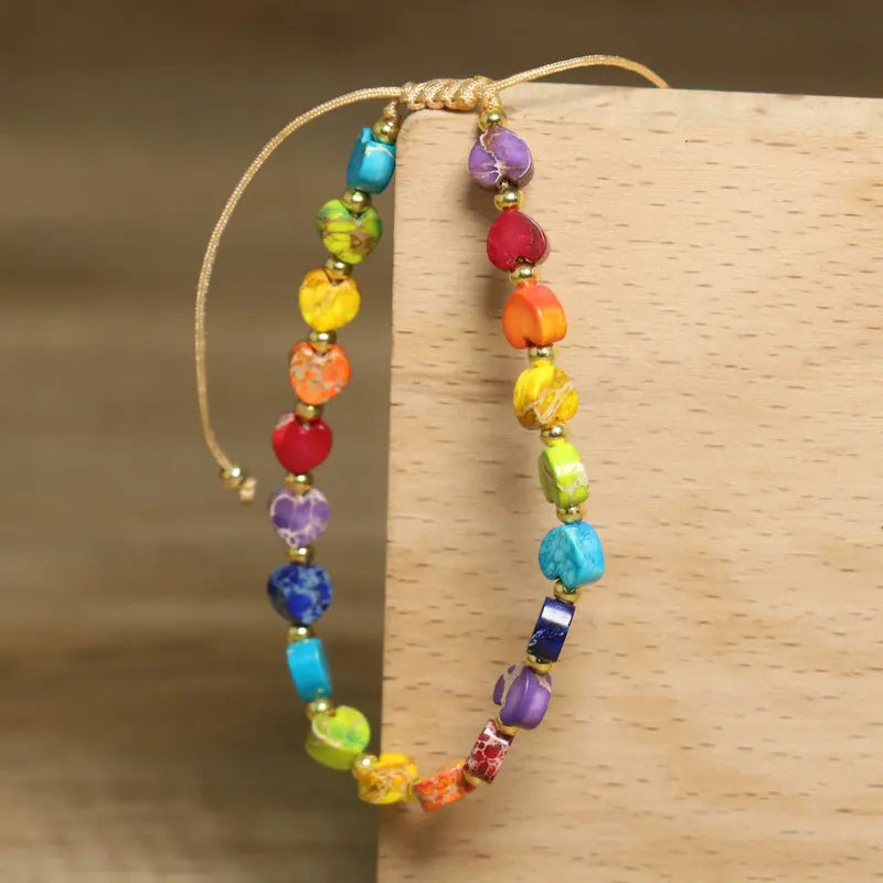 Unisex gemstone beaded bracelet featuring a heart motif, natural stones, colorful, adjustable fit.