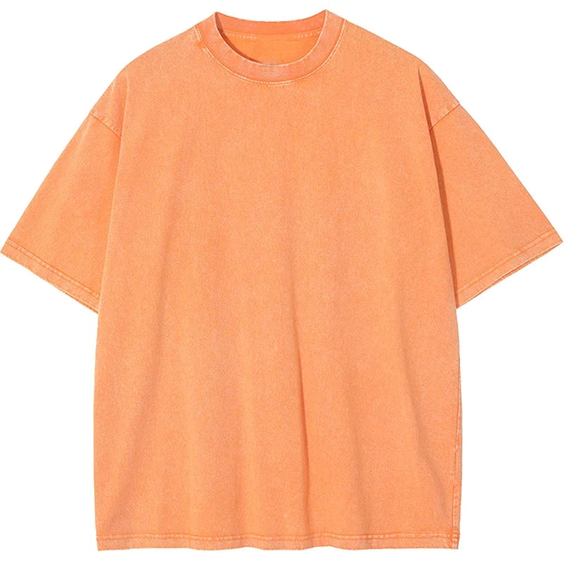 Model wearing a relaxed fit, heavyweight unisex t-shirt, showcasing its retro style and boxy cut. Garment dyed.