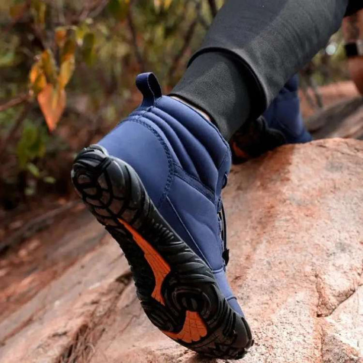 Close-up of flexible sole on unisex high-top barefoot trail shoes, ideal for outdoor hiking