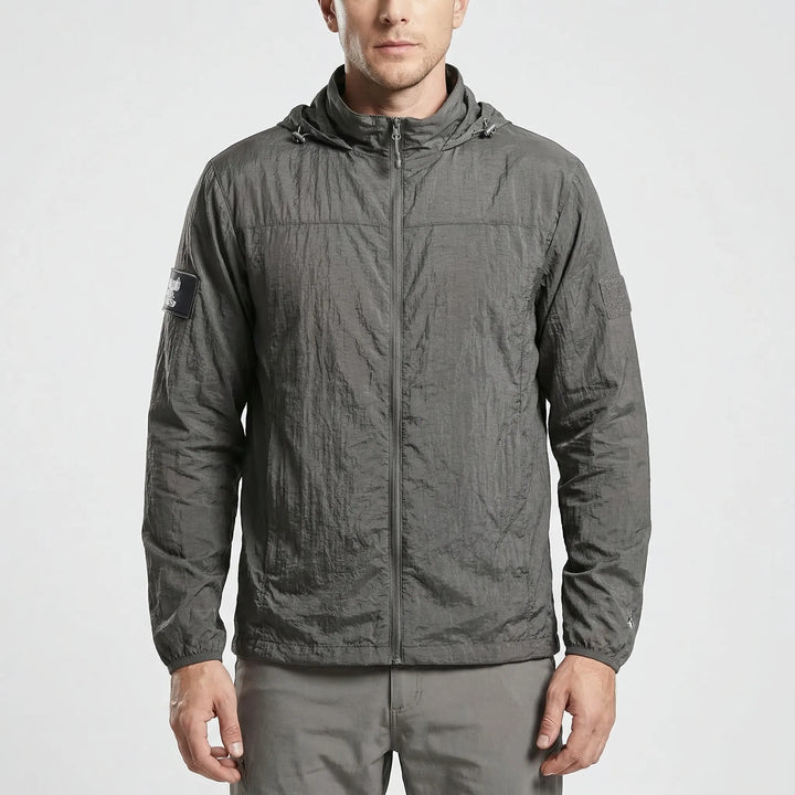 Folded lightweight tactical windbreaker jacket, compact & quick-dry, easy to pack for hiking and outdoor adventures.