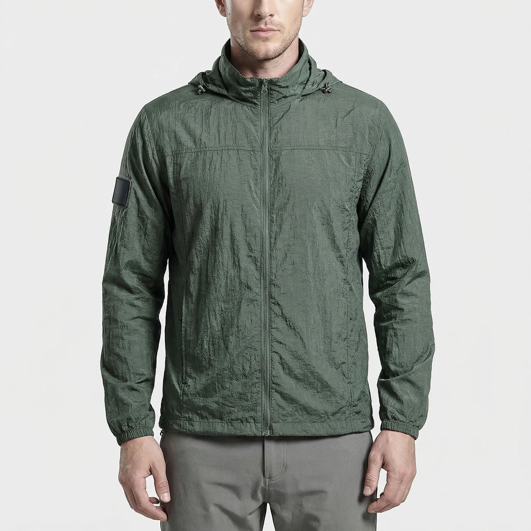 Black unisex hooded lightweight tactical windbreaker jacket with secure zippered pockets. Water repellent & quick dry.