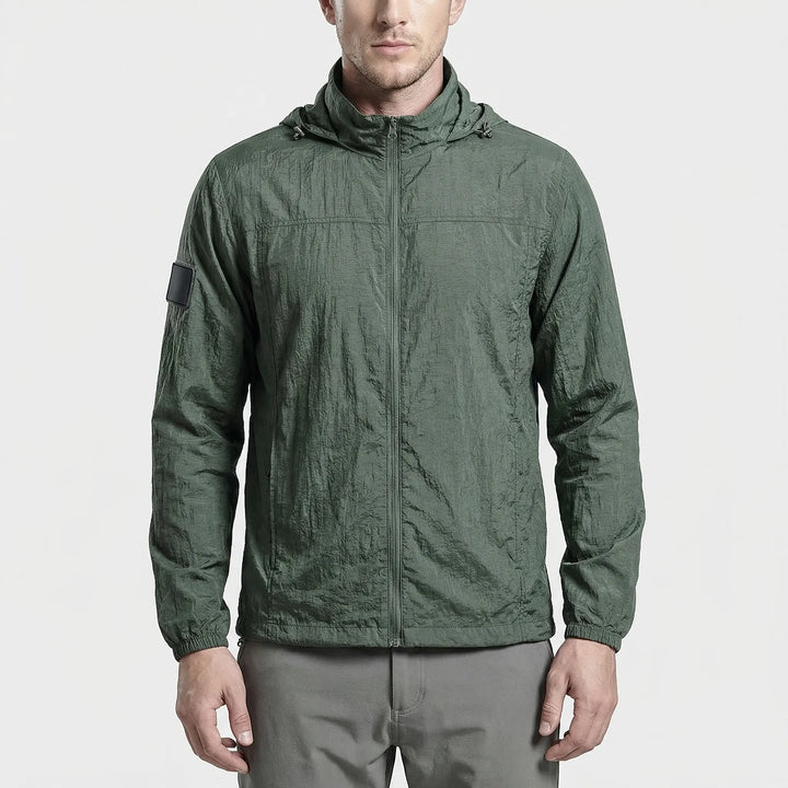 Black unisex hooded lightweight tactical windbreaker jacket with secure zippered pockets. Water repellent & quick dry.