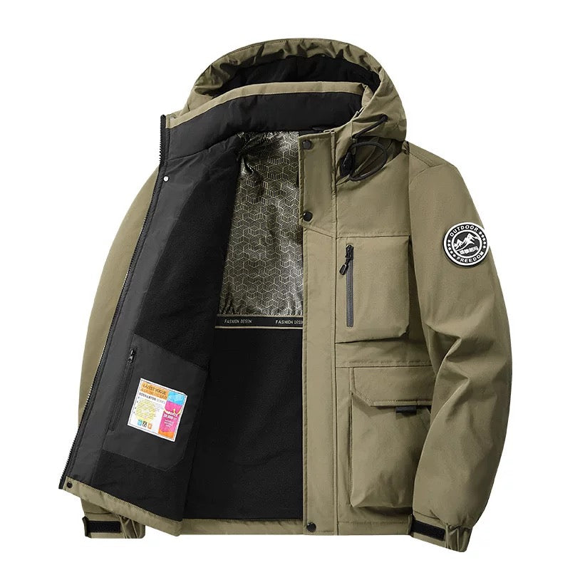 Model wearing a practical unisex hooded waterproof coat. Stay dry & warm in this modern fall & winter jacket.