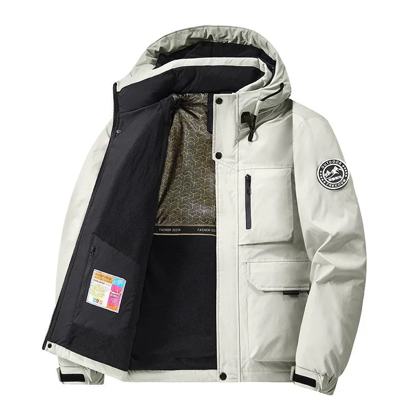 Person walking outdoors in rain wearing a stylish unisex hooded waterproof coat. Essential fall & winter outerwear.