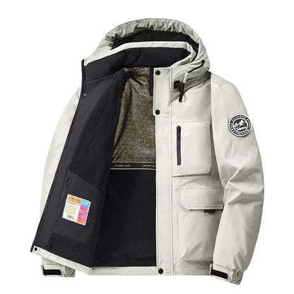 Person walking outdoors in rain wearing a stylish unisex hooded waterproof coat. Essential fall & winter outerwear.