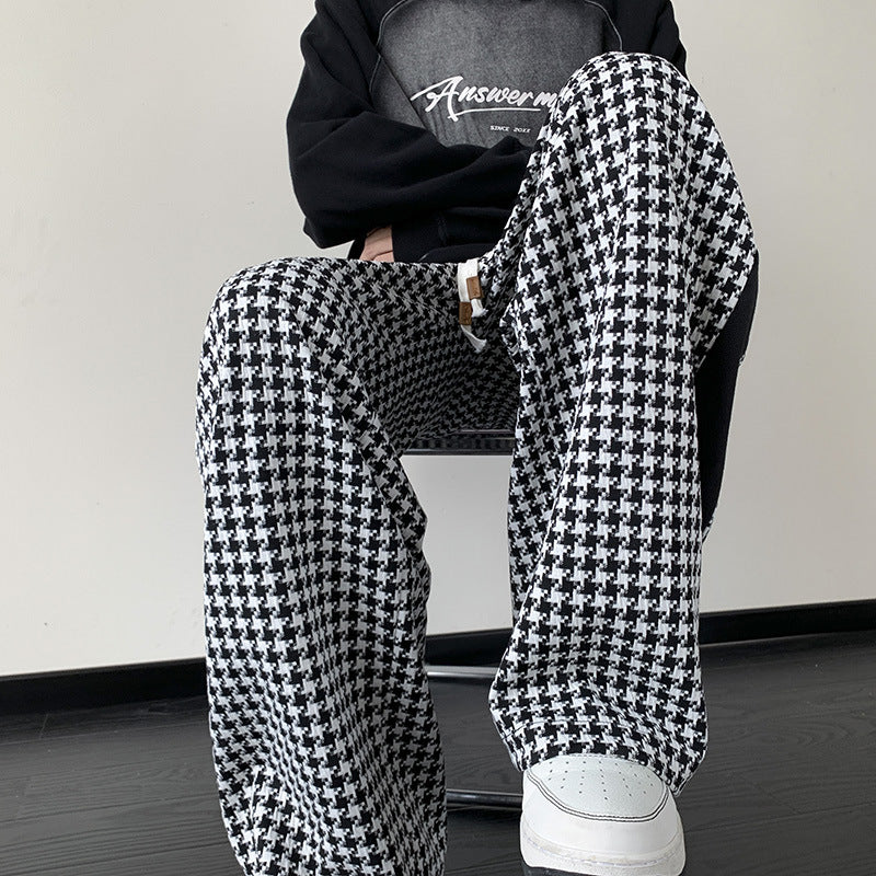 Chic unisex black and brown houndstooth wide-leg sweatpants with grid print, perfect for streetwear or lounge.