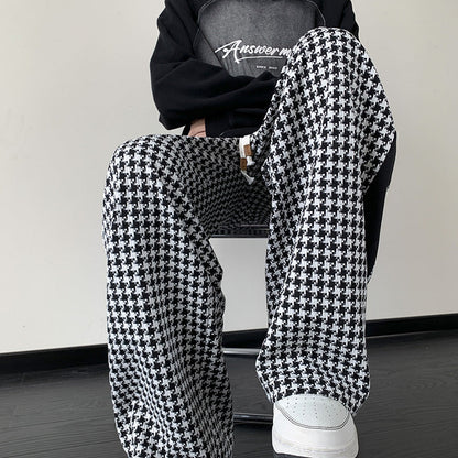 Chic unisex black and brown houndstooth wide-leg sweatpants with grid print, perfect for streetwear or lounge.
