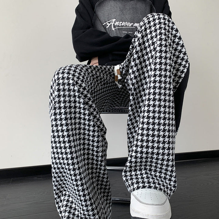 Chic unisex black and brown houndstooth wide-leg sweatpants with grid print, perfect for streetwear or lounge.