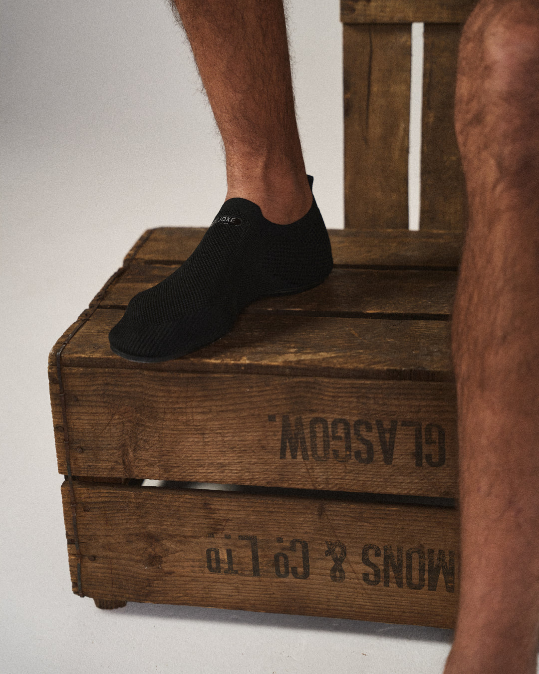Detail of the breathable mesh knit texture on comfortable unisex barefoot slip-on shoes.