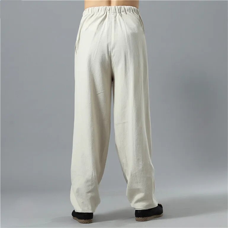 Model walking in relaxed fit Kodama baggy pants, suitable for casual wear and active everyday fashion.