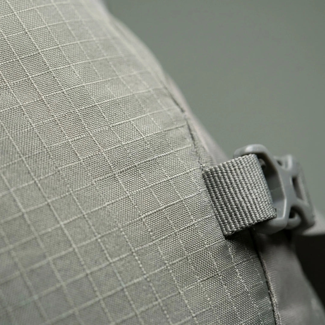 Close-up of the waterproof fabric & reinforced stitching on a durable outdoor travel backpack for long treks.