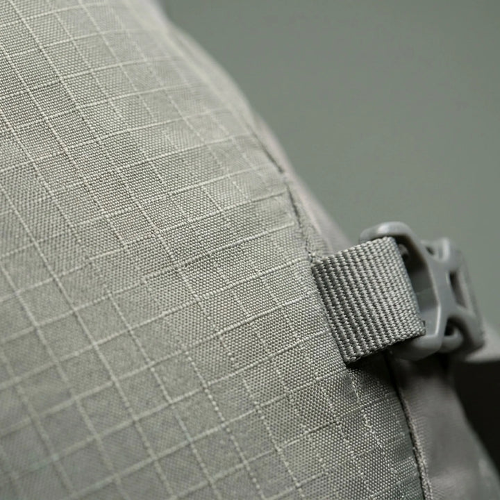 Close-up of the waterproof fabric & reinforced stitching on a durable outdoor travel backpack for long treks.