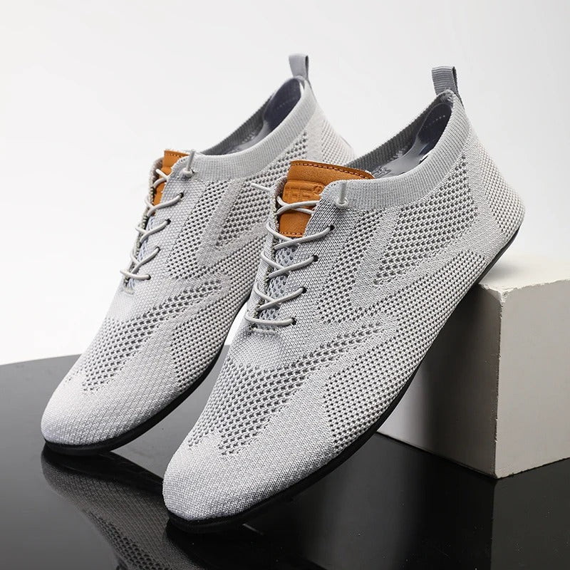 Black unisex lightweight mesh knit slip-on sneakers, ideal for comfortable athletic casual wear.