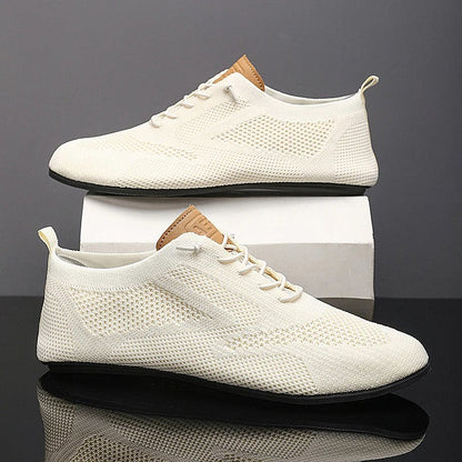 Comfortable slip-on knit sneakers for men and women, lightweight mesh design for breathability.