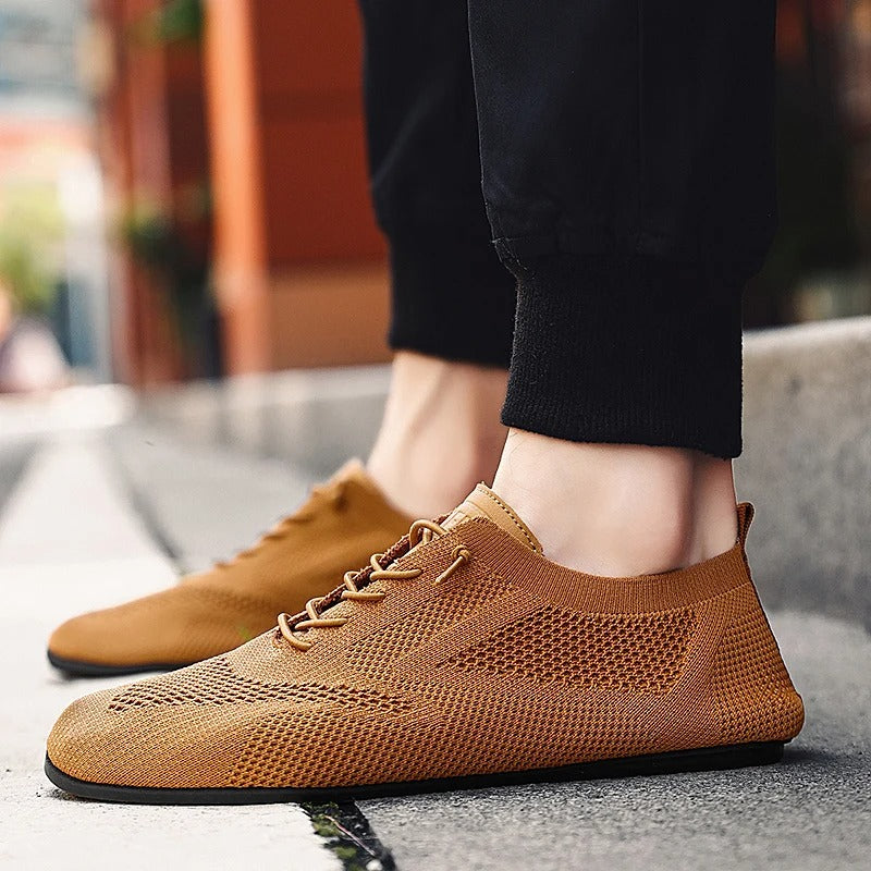 Breathable mesh upper on unisex slip-on knit sneakers, perfect for warm weather casual wear.