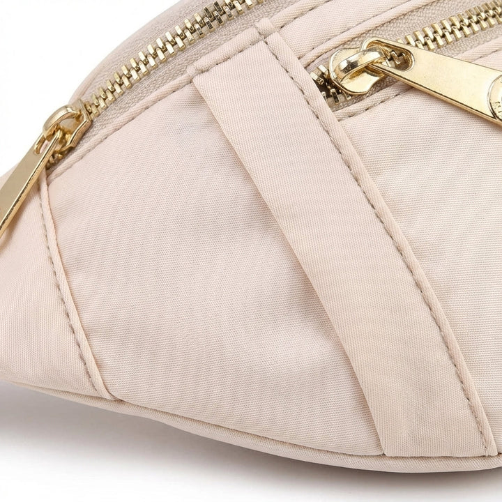 Close-up of a lightweight nylon waist bag, highlighting secure zippered pockets for essentials.