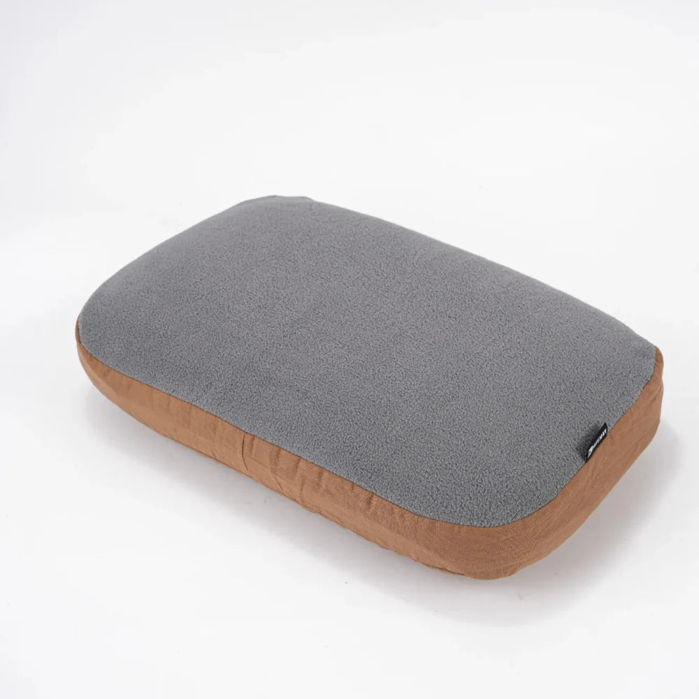 Dual-sided memory foam travel pillow providing neck support for camping comfort