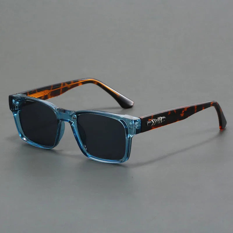 Modern square sunglasses with colored lenses, unisex, offering full UV protection. Trendy fashion.