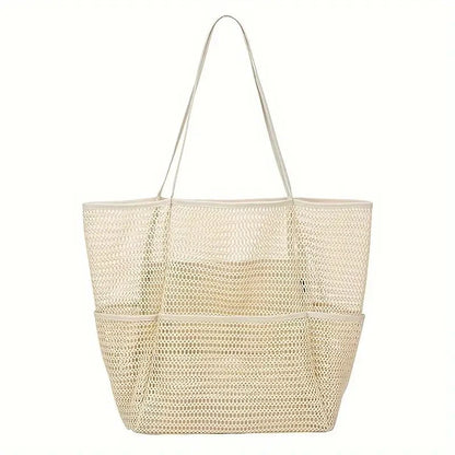Versatile multi-pocket mesh beach bag in black, shown holding various beach essentials, for outdoor use
