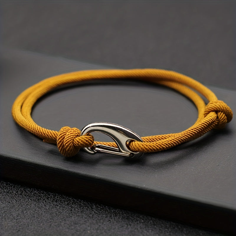 Unisex nautical rope bracelet with silver hook clasp. Adjustable, durable ocean-inspired fashion accessory.