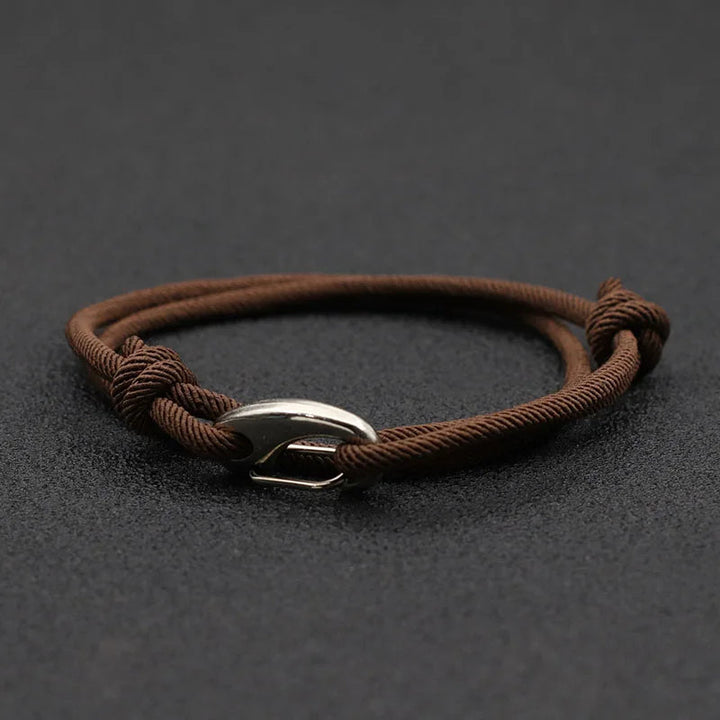 Adjustable unisex nautical rope bracelet featuring a sleek metal hook. Stylish and durable for all genders.