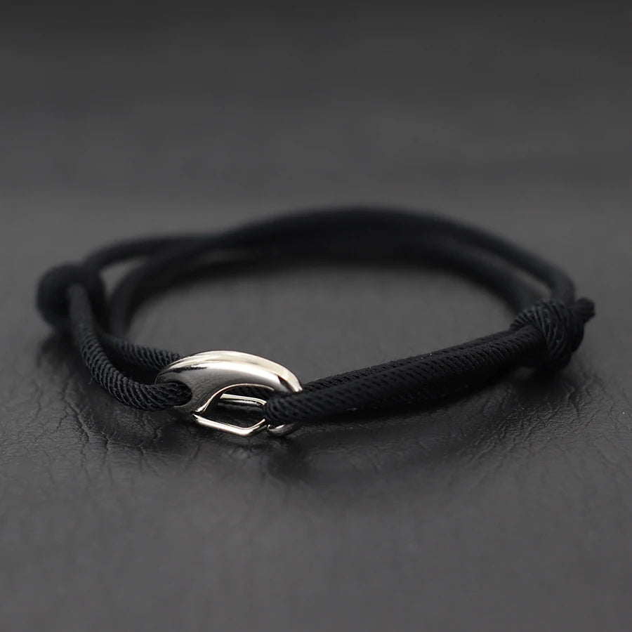 Fashionable unisex rope bracelet with a distinct hook clasp, inspired by nautical themes. Adjustable & waterproof.