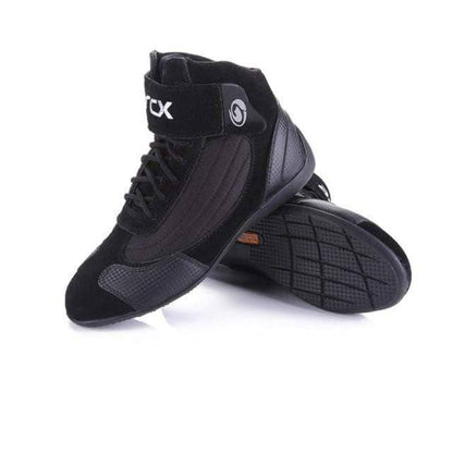 Pair of durable adventure motorcycle boots, gray and black, designed for all-season off-road riding.