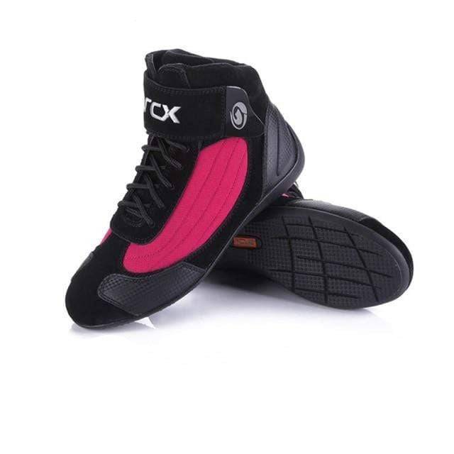 Close-up of the sole of a unisex off-road motorcycle boot, showing aggressive tread for grip.
