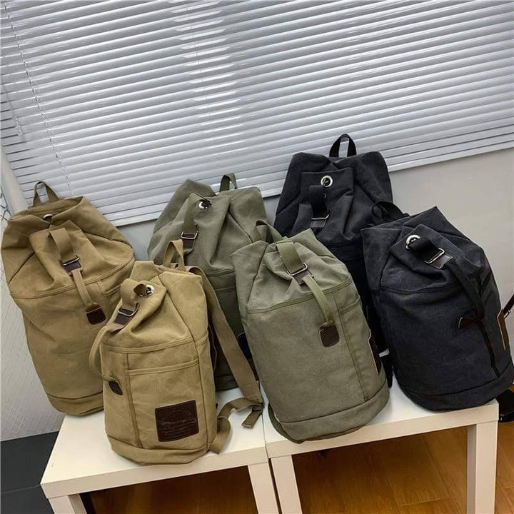 Durable tan canvas hiking rucksack for outdoor adventures, shown with roll-top and side pockets.